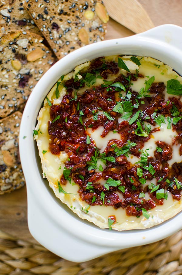 Baked Camembert cheese with sun dried tomatoes and red pepper jelly is the perfect appetizer. | livinglou.com