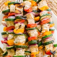 Grilled salmon skewers with zucchini, onion and bell peppers are marinated in a olive oil, lemon juice and dried thyme marinade. | www.livinglou.com
