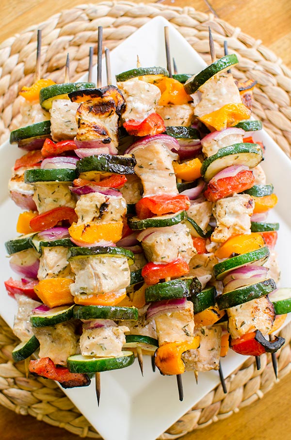 Grilled salmon skewers with zucchini, onion and bell peppers are marinated in a olive oil, lemon juice and dried thyme marinade. | www.livinglou.com