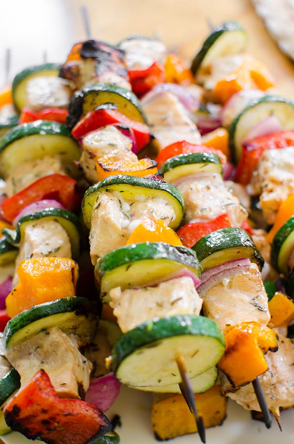 Grilled salmon skewers with zucchini, onion and bell peppers are marinated in a olive oil, lemon juice and dried thyme marinade. | www.livinglou.com
