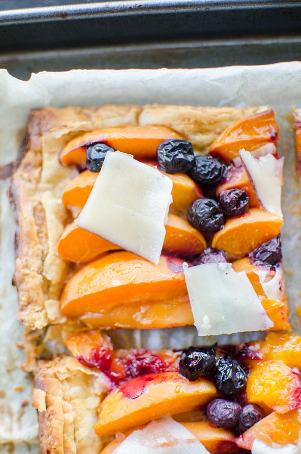 Make the perfect summer dessert with this simple puff pastry apricot blueberry tart topped with Tipsy cheese. | livinglou.com