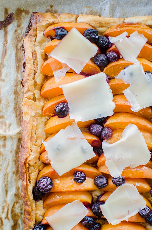 Make the perfect summer dessert with this simple puff pastry apricot blueberry tart topped with Tipsy cheese. | livinglou.com