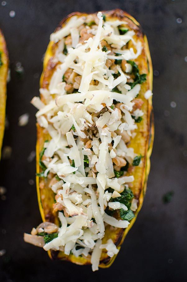 Farro, kale and sausage come together perfectly in this hearty stuffed delicata squash, topped with Canadian Le Gré des Champs cheese. | livinglou.com