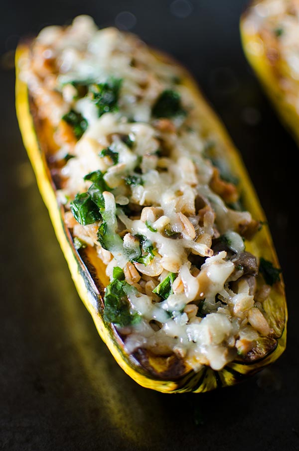 Farro, kale and sausage come together perfectly in this hearty stuffed delicata squash, topped with Canadian Le Gré des Champs cheese. | livinglou.com