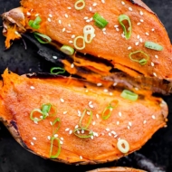 Closeup of cooked sweet potato halves on a baking sheet