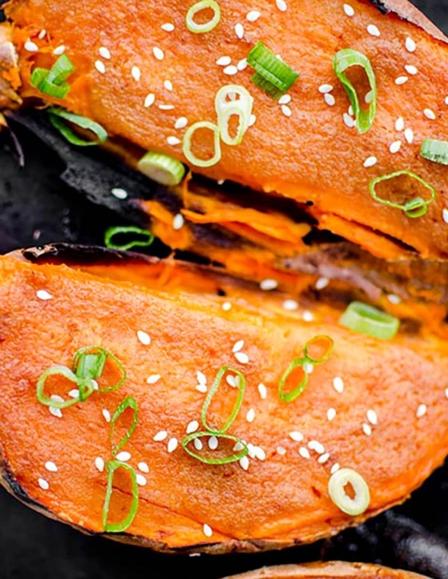 Closeup of cooked sweet potato halves on a baking sheet