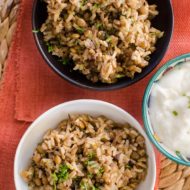 Brown rice mujaddara in bowls with parsley on top