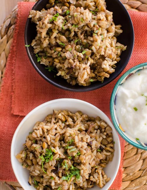 Brown rice mujaddara in bowls with parsley on top