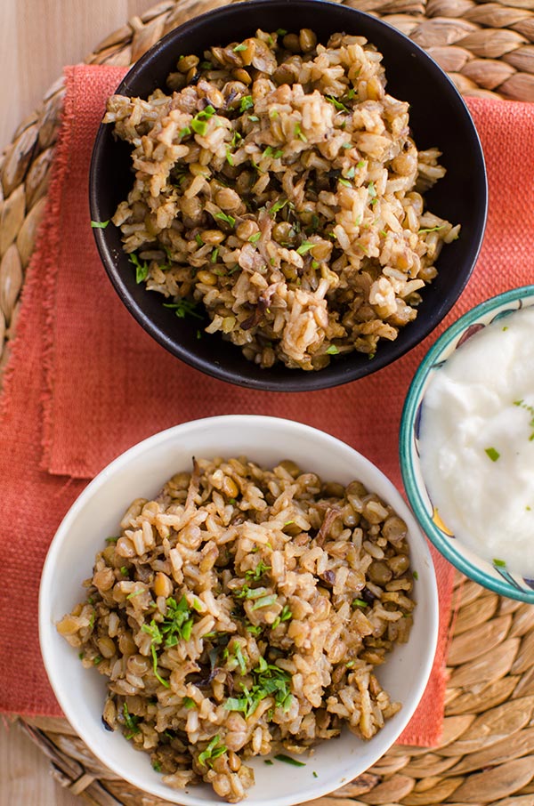 Brown rice mujaddara in bowls with parsley on top