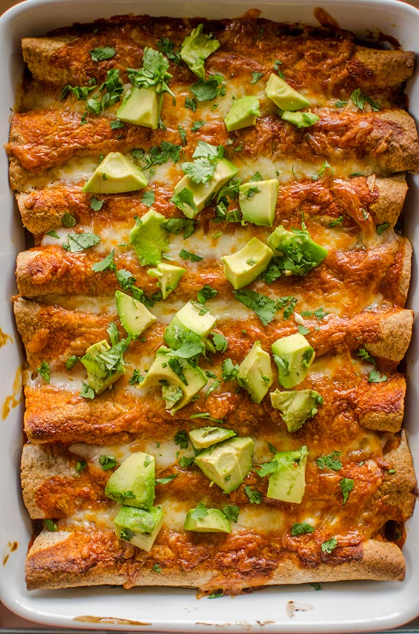 Chicken and black bean enchiladas with red sauce are perfect for a Mexican-inspired dinner. | livinglou.com
