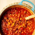 Closeup of chili in a turquoise Dutch oven.