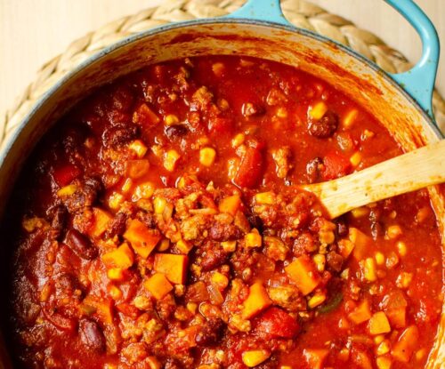 Closeup of chili in a turquoise Dutch oven.