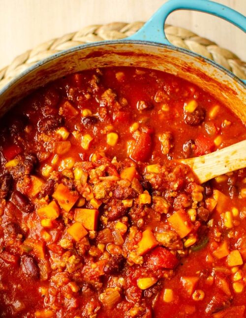 Closeup of chili in a turquoise Dutch oven.