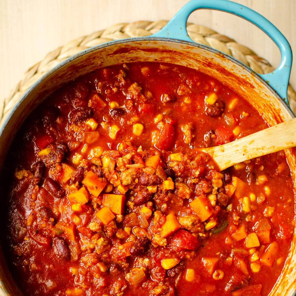 Closeup of chili in a turquoise Dutch oven.