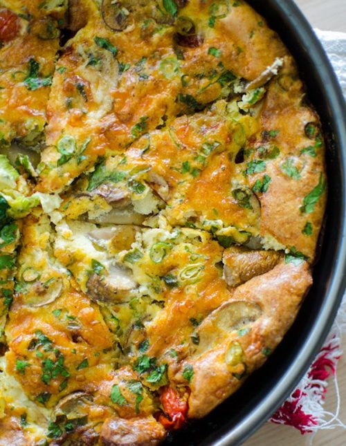 Blistered tomato and mushroom frittata in the pan