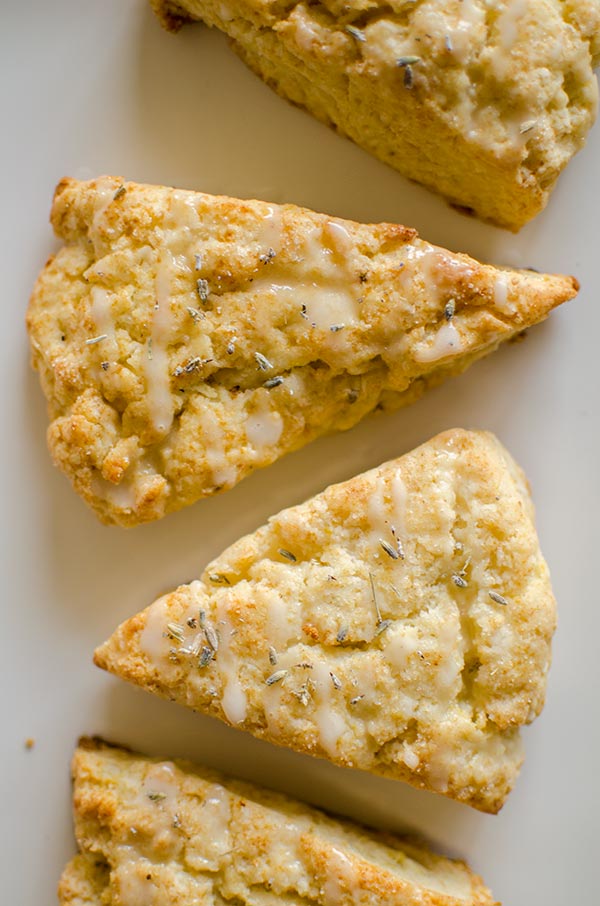 Light and fluffy homemade lemon scones with a lemon glaze and sprinkled with lavender. | livinglou.com