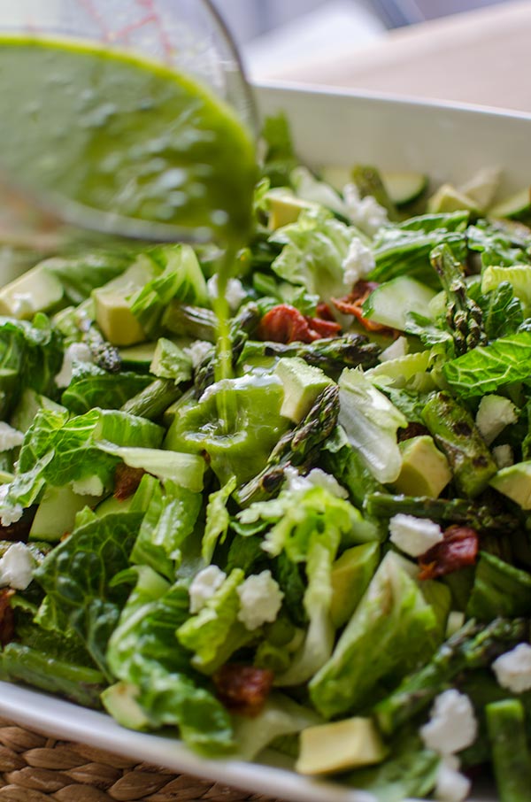 Grilled asparagus salad with basil vinaigrette is the perfect early summer salad with avocado, goats cheese and sundried tomatoes. | livinglou.com