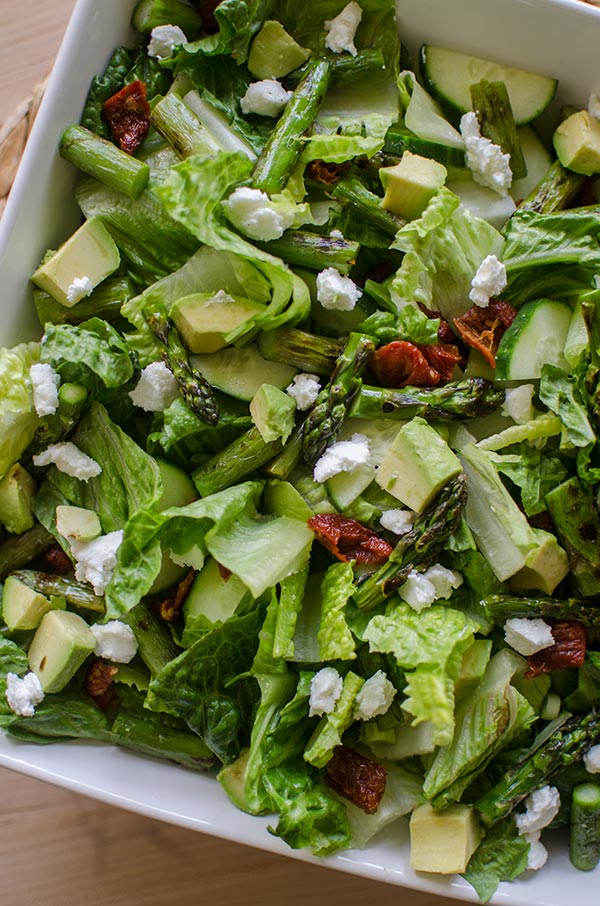 Grilled asparagus salad with basil vinaigrette is the perfect early summer salad with avocado, goats cheese and sundried tomatoes. | livinglou.com