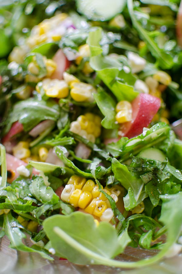 Charred corn and arugula salad with peaches is the perfect bright summer salad with basil and feta. | livinglou.com