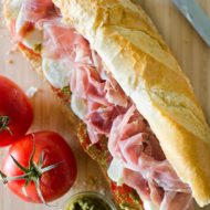 Prosciutto mozzarella and pesto marinated tomato sandwich. | livinglou.com