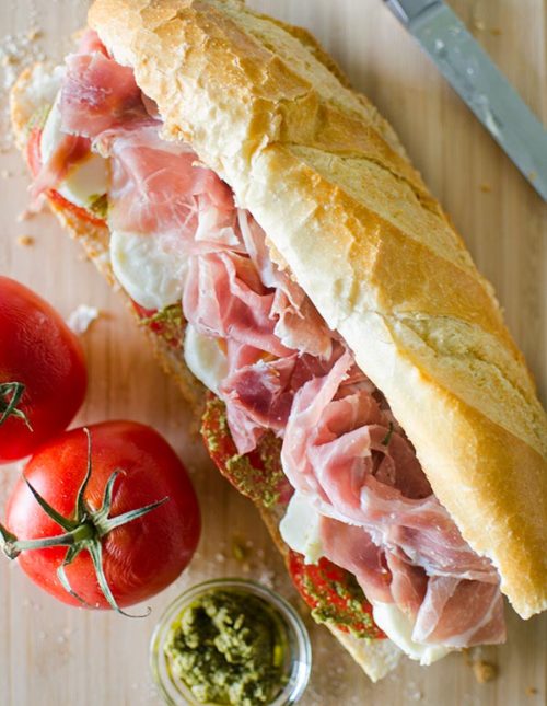 Prosciutto mozzarella and pesto marinated tomato sandwich. | livinglou.com