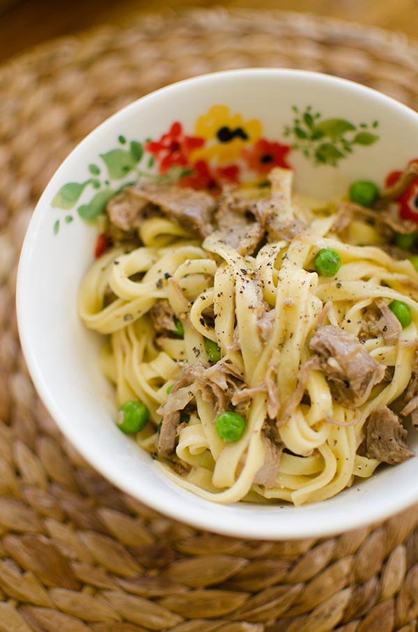 Make a delicious pasta with a slow braised lamb ragu made with lamb shoulder chops and peas. | livinglou.com