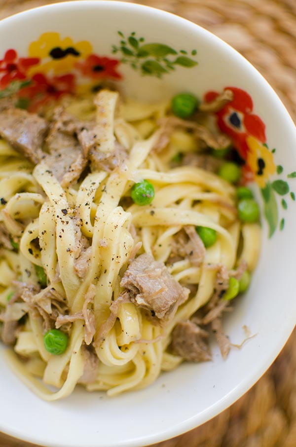 Make a delicious pasta with a slow braised lamb ragu made with lamb shoulder chops and peas. | livinglou.com