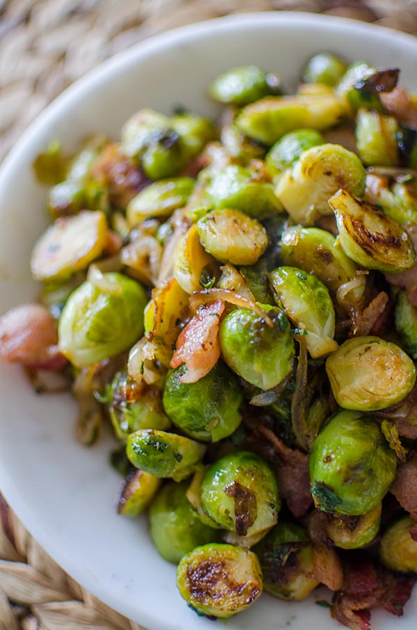 Make the best Brussels sprouts this holiday season with this recipe for Brussels sprouts with bacon and onions with sage and maple syrup. | livinglou.com