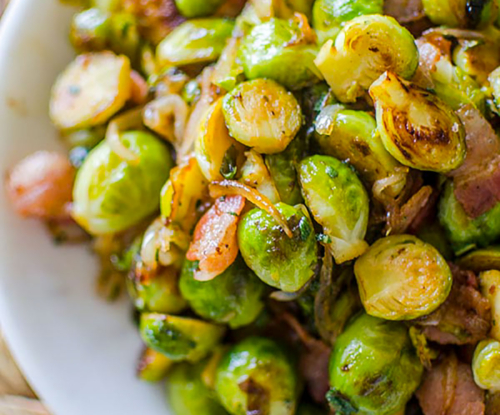 Cooked Brussels sprouts in a white bowl