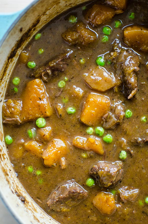 Make the perfect melt in your mouth and tender beef and butternut squash stew, made with stewing beef, butternut squash and peas. | livinglou.com