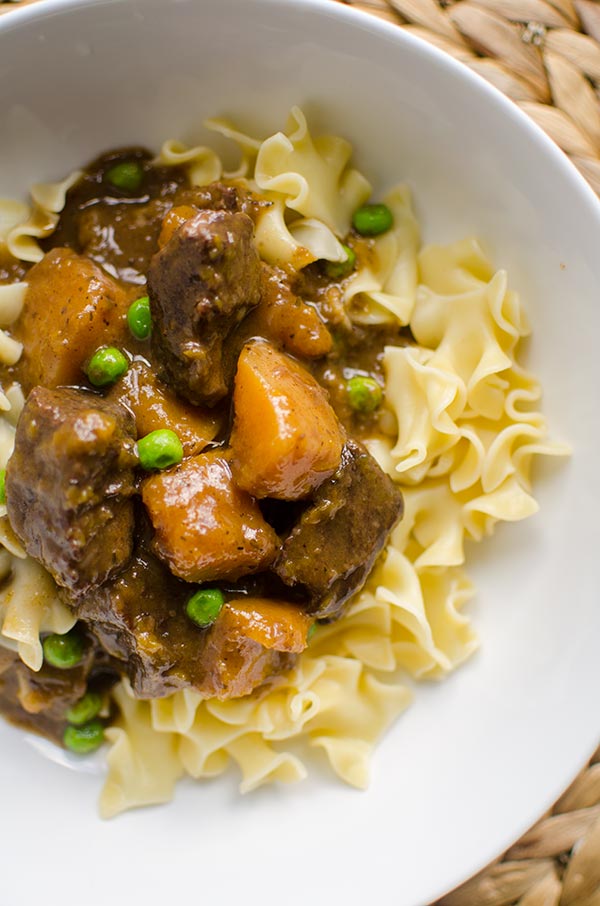 Make the perfect melt in your mouth and tender beef and butternut squash stew, made with stewing beef, butternut squash and peas. | livinglou.com