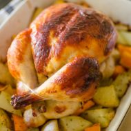 Buttermilk roast chicken in a dish of potatoes and sweet potatoes