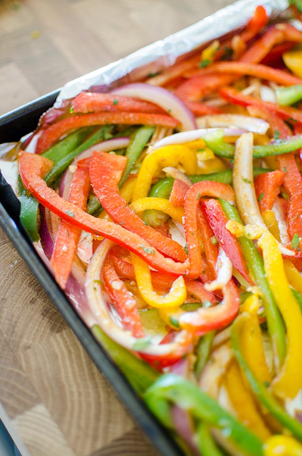 Bell peppers and onions in a fajita marinade.