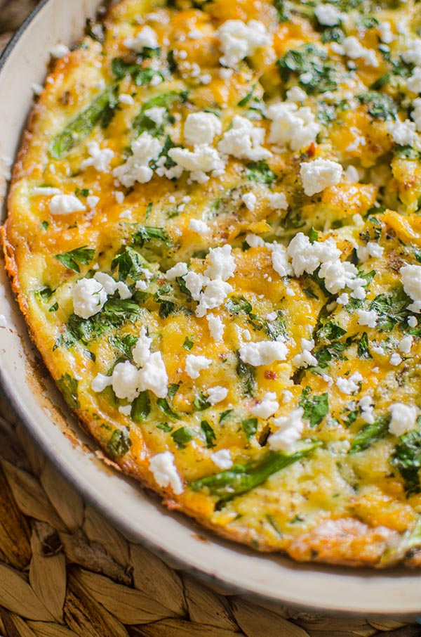 Closeup of bacon and asparagus frittata topped with feta.