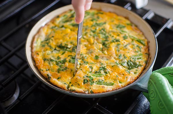 Slicing bacon and asparagus frittata.