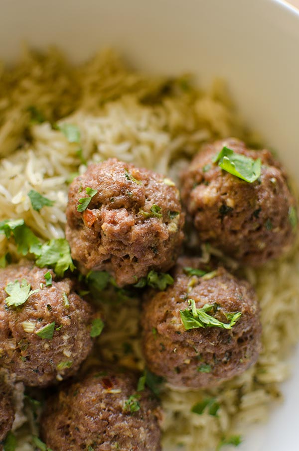 Closeup of Korean meatballs on jasmine rice with cilantro.