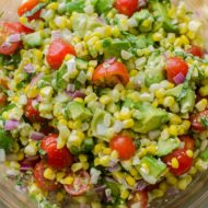 Avocado corn salad in a glass bowl.