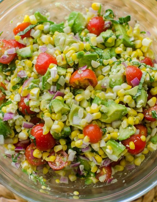 Avocado corn salad in a glass bowl.