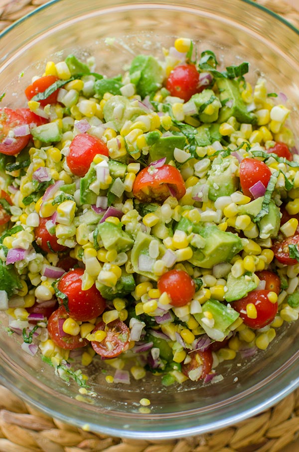 Avocado corn salad in a glass bowl.