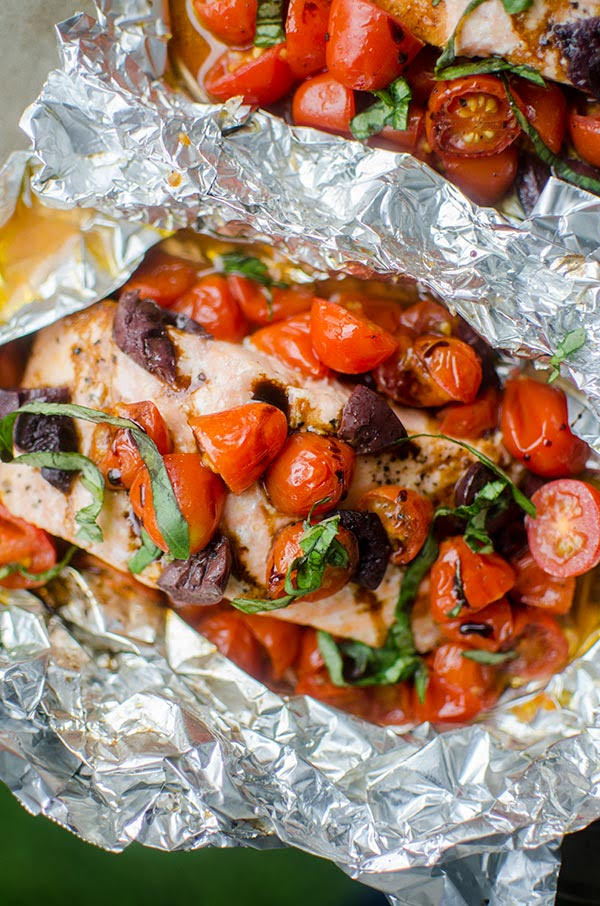 Grilled salmon in foil with local cherry tomatoes, fresh basil, kalamata olives and balsamic glaze.