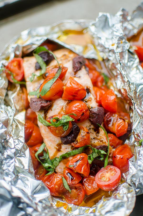 Grilled salmon in foil with cherry tomatoe, kalamata olives, basil and drizzled with balsamic glaze.