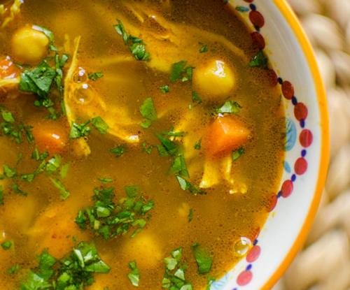 Moroccan chicken soup in a bowl with cilantro.
