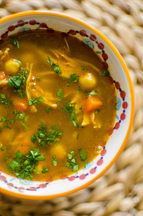 Moroccan chicken soup in a bowl with cilantro.