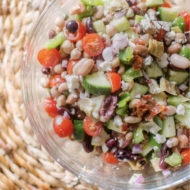 Easy mediterranean bean salad in a glass bowl.