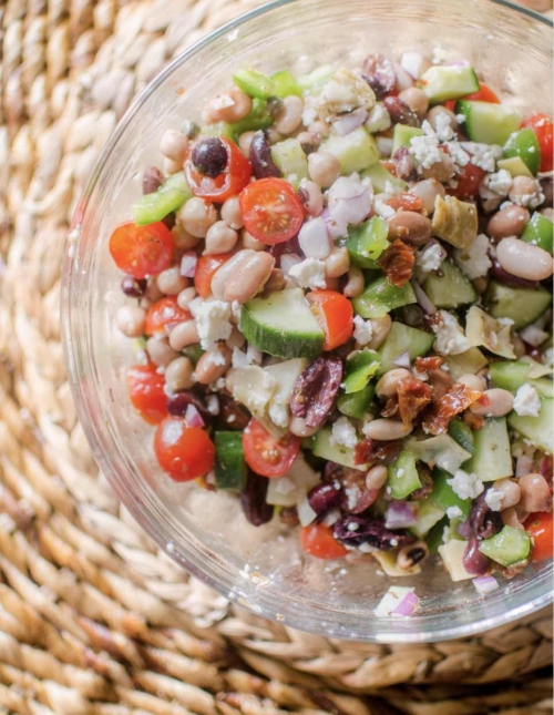 Easy mediterranean bean salad in a glass bowl.