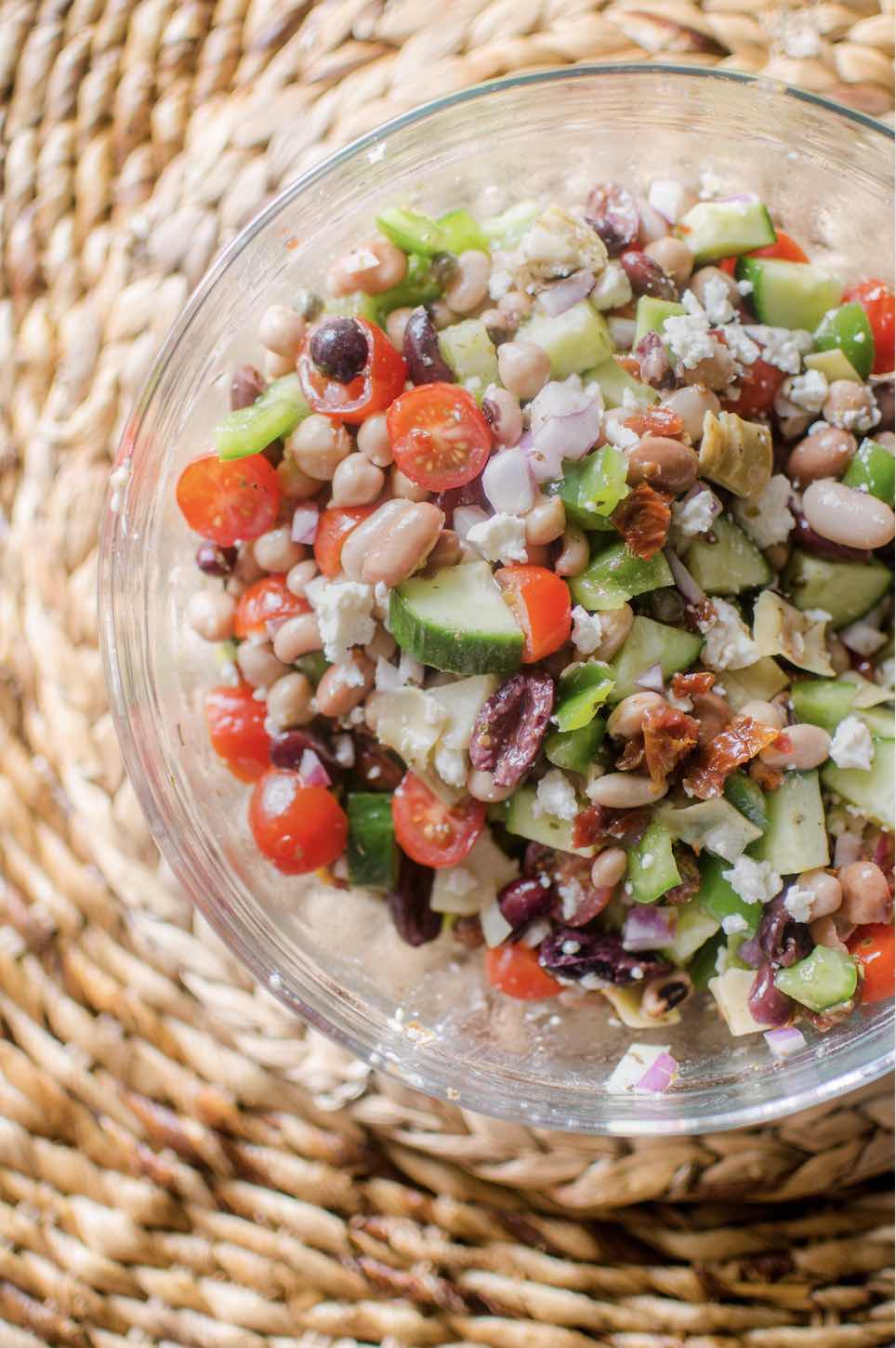 Easy mediterranean bean salad in a glass bowl.