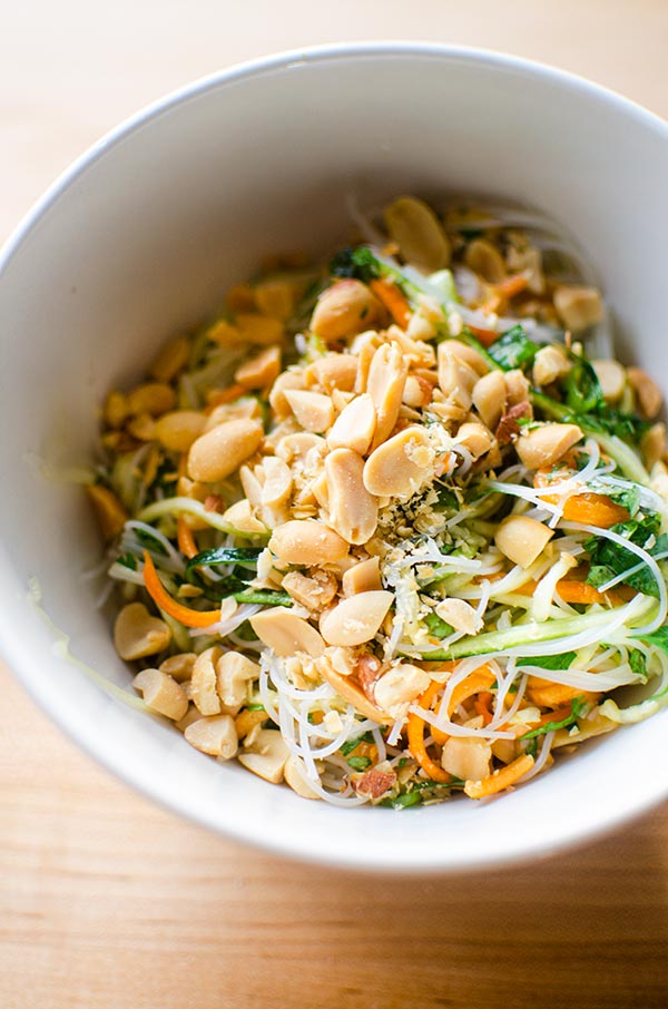 Vermicelli noodle salad in a bowl topped with salted peanuts