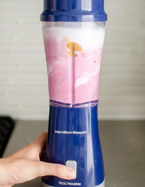 Triple berry smoothie in the blender being blended.