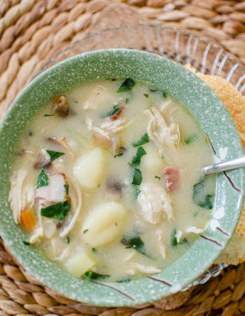 Chicken gnocchi soup in a green bowl