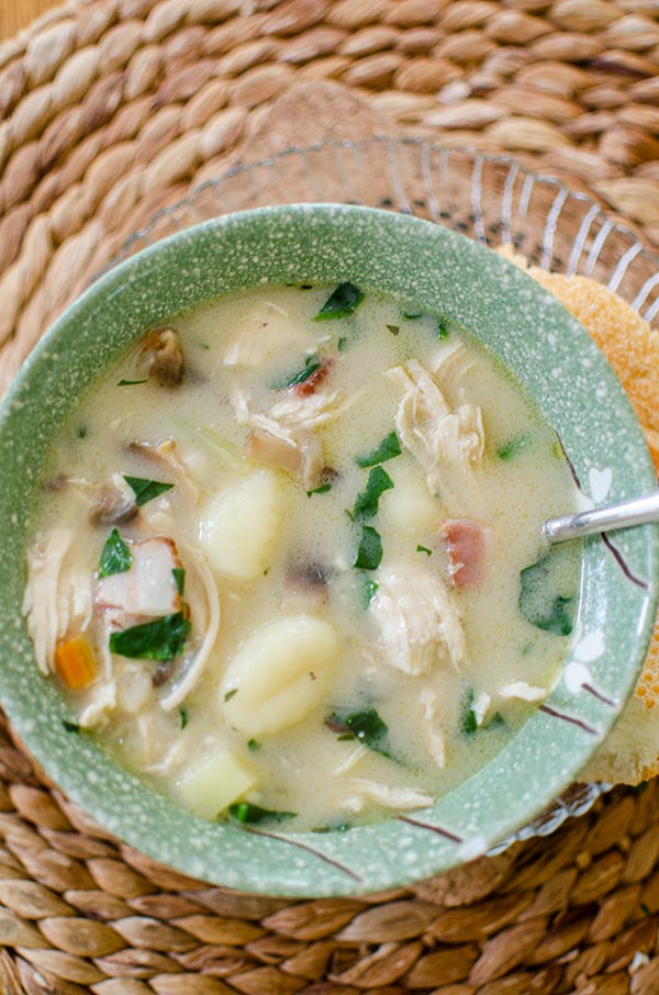 Chicken gnocchi soup in a green bowl